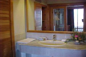 a bathroom with a sink and a mirror at Rock City Resort in Mingāora