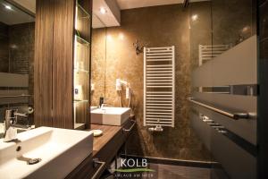 a bathroom with a sink and a mirror at Hotel Kolb in Langeoog