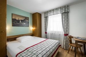 מיטה או מיטות בחדר ב-Hotel Pradat