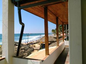 a view of the beach from the balcony of a beach house at Sunnys Beach Guest House in Hikkaduwa
