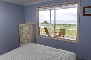 A bed or beds in a room at Seascape Beach House