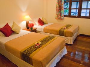 Ein Bett oder Betten in einem Zimmer der Unterkunft Baan Klang Aow Beach Resort