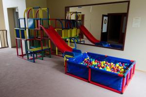 a play room with a bunch of playground equipment at Port Hotel in Ādaži