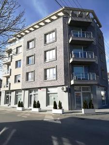 a large brick building on the side of a street at Astoria in Hisarya