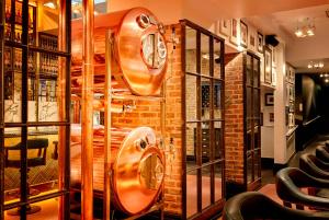 a room with a wall of wine barrels at Black Ivy in Edinburgh