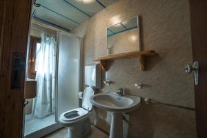 a bathroom with a sink and a toilet and a shower at Bungalow al Lago in Ledro +25 photos