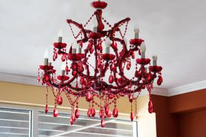 a red chandelier hanging from a ceiling at Saint Catherine Hotel in Pythagoreio