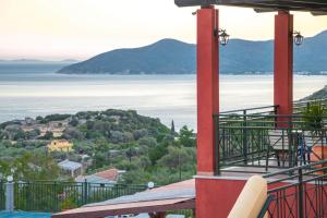 a view of the water from the balcony of a house at Saint Catherine Hotel in Pythagoreio