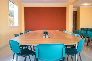a conference room with a large wooden table and chairs at Saint Catherine Hotel in Pythagoreio