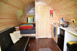a small room with a bed in a tiny house at Dunvegan Camping Pods in Dunvegan