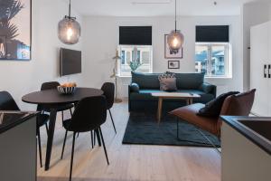 a living room with a couch and a table at Frogner House - Grünerløkka in Oslo