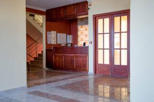 an empty room with a door and a staircase at Saint Catherine Hotel in Pythagoreio