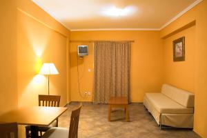 a living room with a couch and a table at Saint Catherine Hotel in Pythagoreio