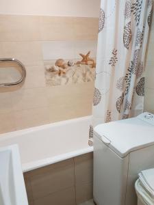 a bathroom with a shower curtain with animals on it at 2 Bedroom Lux Apartments in Rīga