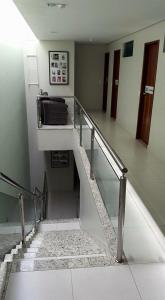 a hallway with stairs in a building with a stair case at POUSADA CAJÁ in Flores