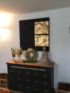 a dresser with a mirror on top of it at A casa di Romeo in Madesimo