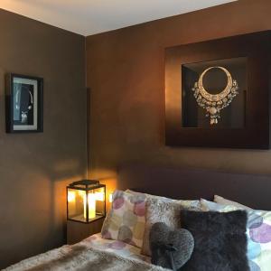 a bedroom with a bed and a mirror on the wall at A casa di Romeo in Madesimo