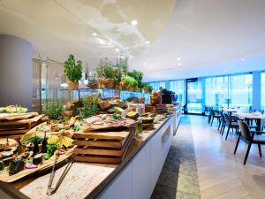 a buffet line in a restaurant with tables and chairs at VacationClub - Baltic Park Molo Apartment D203 in Świnoujście