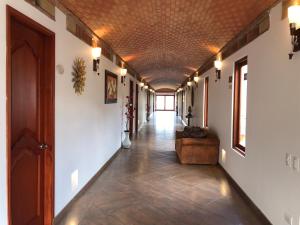 a hallway with a couch and a ceiling at Hotel Puente Piedra in Villa de Leyva +131 photos