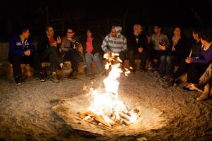 a crowd of people standing around a fire pit at Nayara Alto Atacama in San Pedro de Atacama