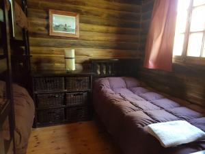 
Una cama o camas en una habitación de Posta Nehuen Cabañas
