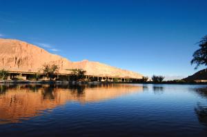 a large body of water with a mountain in the background at Nayara Alto Atacama in San Pedro de Atacama +94 photos