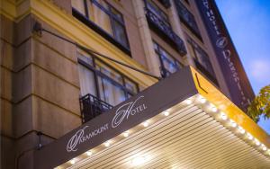 a street sign in front of a building with lights at The Paramount Hotel in Seattle