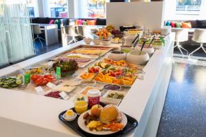 una línea de buffet con muchos tipos diferentes de comida en Comfort Hotel Eskilstuna, en Eskilstuna