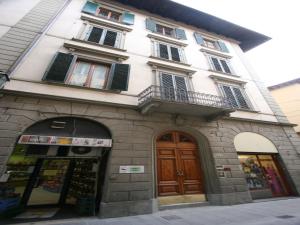 een wit gebouw met ramen en deuren aan een straat bij Casa Billi in Florence