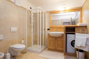 a bathroom with a toilet sink and a shower at Hotel Al Prato in Fiera di Primiero +39 photos