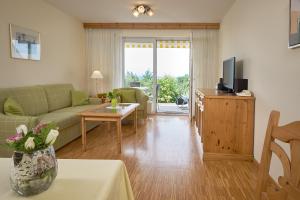 a living room with a couch and a table at Ferienhaus Rheintalblick in Bad Bellingen