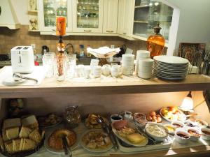 a kitchen counter with many plates of food on it at Armonia Hotel in Kefalari