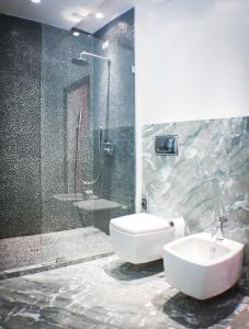 a bathroom with a shower and a toilet and a sink at Palazzo dei Concerti in Torre Annunziata