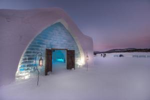 an igloo building in the snow at night at Hotel de Glace in Saint-Gabriel-De-Valcartier