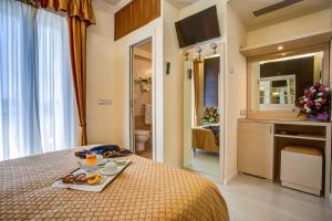 Postel nebo postele na pokoji v ubytování Hotel Caesar Paladium