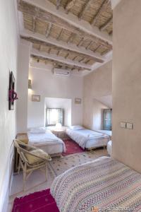 A bed or beds in a room at Kasbah Agoulzi