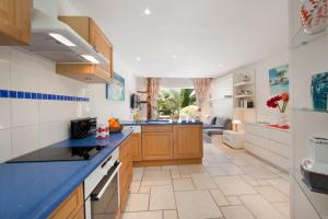 a kitchen with wooden cabinets and a blue counter top at Studio Cartarana in Bonifacio