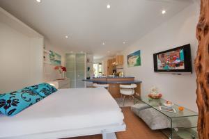 a bedroom with a white bed and a glass table at Studio Cartarana in Bonifacio