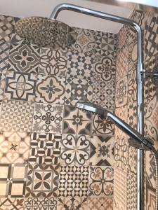 a bathroom with a shower with tiles on the wall at Apartamento in Alicante