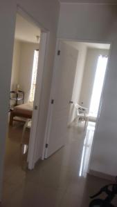 a room with a door and a chair in a room at Departamentos Playa San Bartolo in San Bartolo