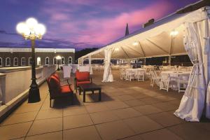 a patio with white tables and chairs and a street light at General Morgan Inn in Greeneville