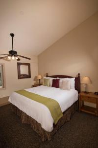 a bedroom with a large bed and a ceiling fan at Falcon Point in Avon