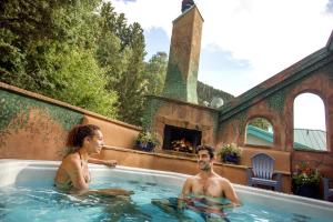 two men in a hot tub in a house at Alpine Village Suites in Taos Ski Valley
