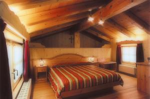 Postel nebo postele na pokoji v ubytování Hotel Garni Plueme