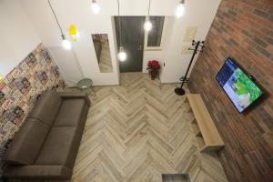 an overhead view of a living room with a couch and a television at Santa Chiara Loft in Naples