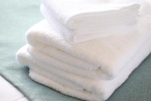 a stack of white towels sitting on a table at Hotel Wing International Select Nagoya Sakae in Nagoya