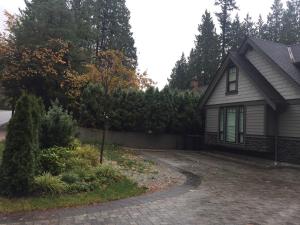 a house with a driveway in front of a house at Vancouver Austin Guesthouse in Coquitlam