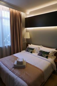 a bedroom with a large bed with a large window at Hotel Gaia 95 in Kota Kinabalu