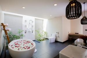 a bathroom with a large tub with flowers on it at Mandarava Resort and Spa, Karon Beach - SHA Extra Plus in Karon Beach