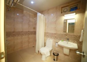 a bathroom with a toilet and a sink at La Lune Fort Kochi in Cochin +37 photos